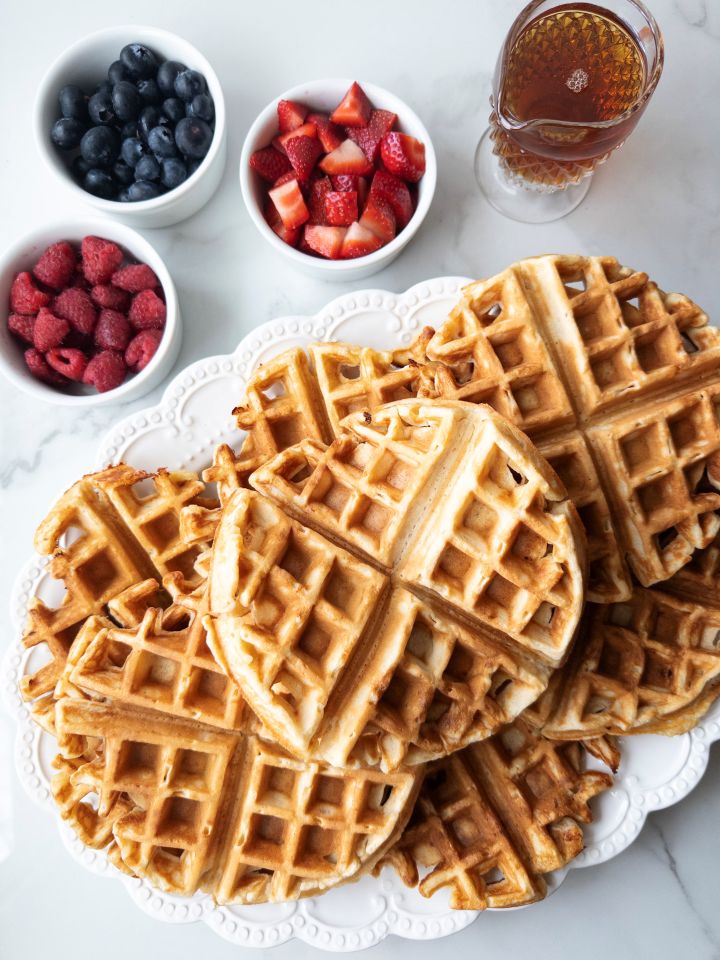 Fresh Milled Waffles with Greek Yogurt on a platter with toppings in the background