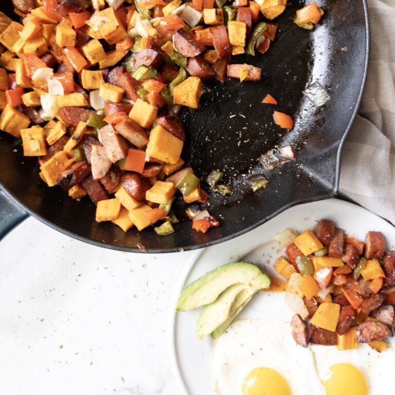 Sweet Potato & Chicken Sausage Skillet with a plate of skillet, eggs, and avocado on the side