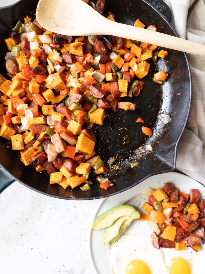 Sweet Potato & Chicken Sausage Skillet with a plate of skillet, eggs, and avocado on the side
