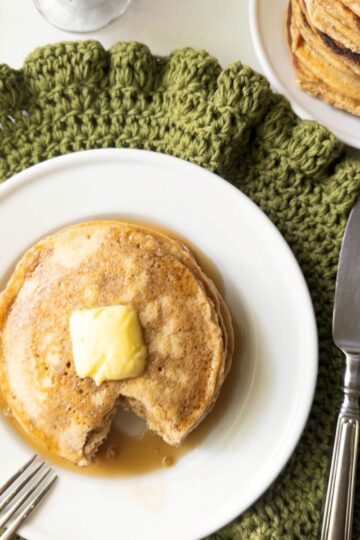 Stack of fresh milled flour buttermilk pancakes topped with butter