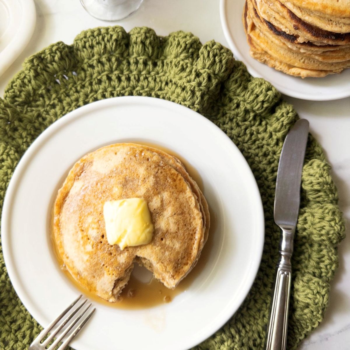 Stack of fresh milled flour buttermilk pancakes topped with butter