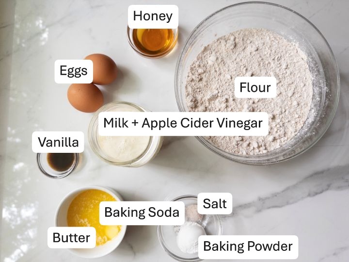 Ingredients for fresh milled flour buttermilk pancakes including honey, flour, and baking soda