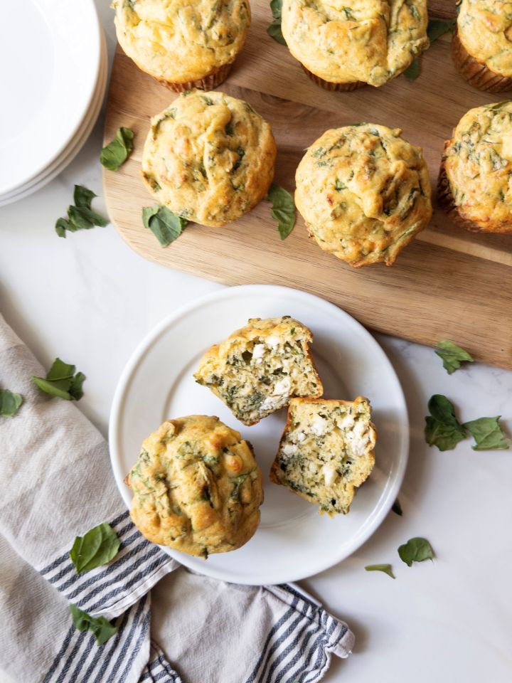 Savory spinach and feta muffin made with fresh milled flour, split open on a plate